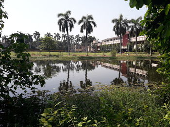 Scenic view of lake and trees against sky