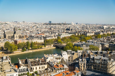  view on paris from roof of notre dame cathedral on bright sunny day