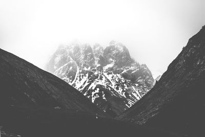 Scenic view of snowcapped mountains against clear sky