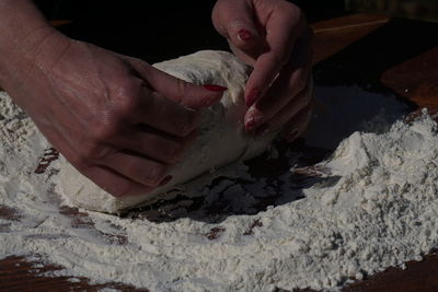 Close-up of person preparing food on table