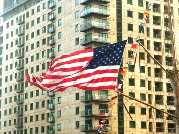 Low angle view of flag against buildings