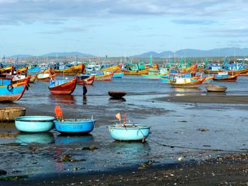 Boats moored on sea against sky