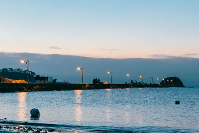 Scenic view of sea against sky at dusk