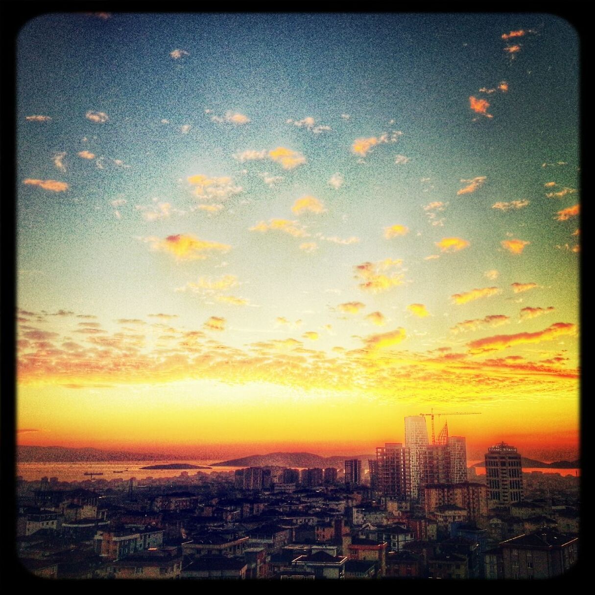 transfer print, cityscape, city, building exterior, architecture, built structure, sunset, crowded, auto post production filter, high angle view, residential district, sky, residential building, city life, orange color, residential structure, skyscraper, aerial view, tower, outdoors