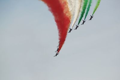 Low angle view of airshow against clear sky