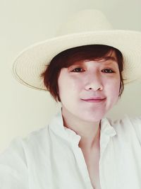 Portrait of young woman wearing sun hat