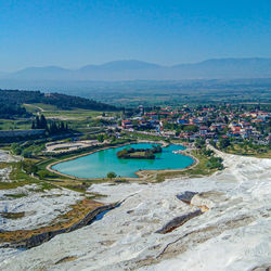 High angle view of river amidst landscape against blue sky