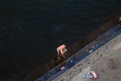 High angle view of man bathing at riverbank