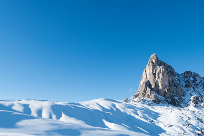 Scenic view of snowcapped mountains against clear blue sky