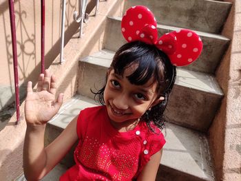 Smiling girl sitting on staircase