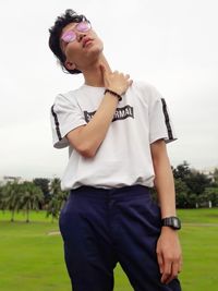 Full length of man standing on field against sky