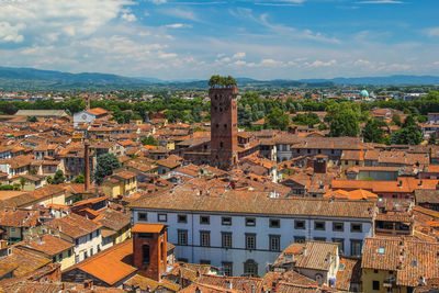 High angle view of old buildings in town against sky