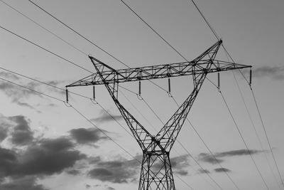 Low angle view of electricity pylon against sky