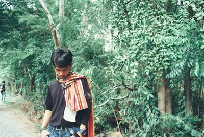 Rear view of man looking at forest