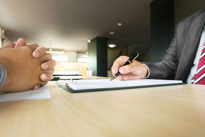 Man and woman in pen on table
