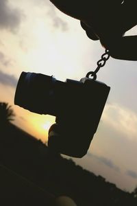 Low angle view of silhouette camera against sky during sunset