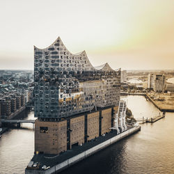 Bridge over river against buildings in city