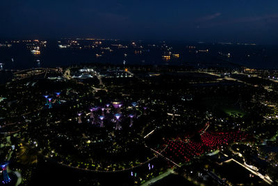 High angle view of illuminated cityscape against sky at night