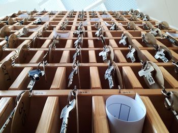 Low angle view of keys hanging in shelf at hotel