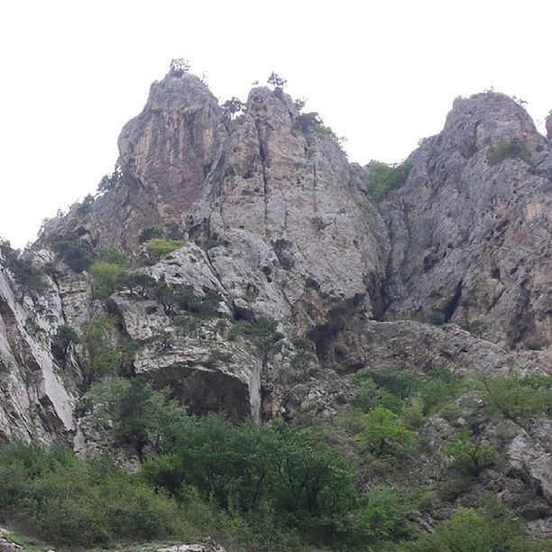 rock formation, rock - object, tranquility, tranquil scene, mountain, geology, nature, scenics, clear sky, beauty in nature, rocky mountains, rock, cliff, physical geography, landscape, eroded, non-urban scene, sky, low angle view, rough