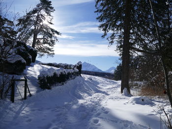 Scenic view of snow covered field against sky