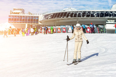 Full length of woman skiing on snow covered land