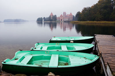 Boats moored in river