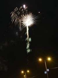 Low angle view of firework display at night