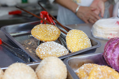 Sweet food in trays on kitchen counter