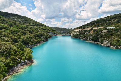 Scenic view of river amidst mountains against sky