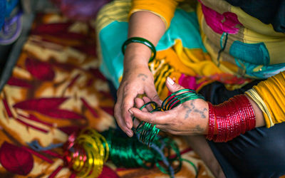 High angle view of woman holding multi colored hand