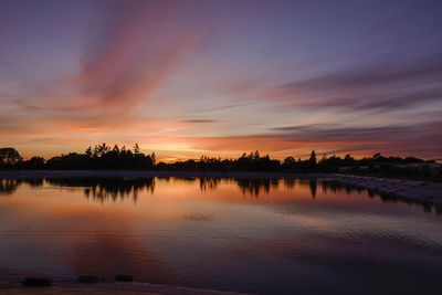 Scenic view of lake against romantic sky at sunset