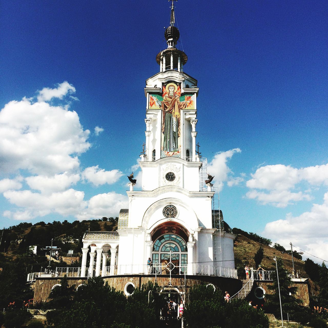 religion, church, place of worship, architecture, building exterior, spirituality, built structure, low angle view, cathedral, sky, tower, clock tower, cross, blue, clock, famous place, travel destinations, bell tower