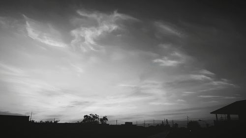 Low angle view of silhouette trees against sky