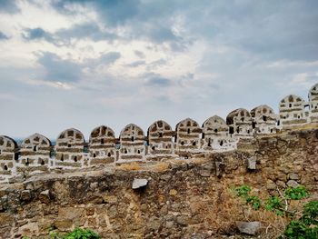 Low angle view of historical building against cloudy sky