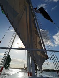 Low angle view of sailboat sailing on sea against sky