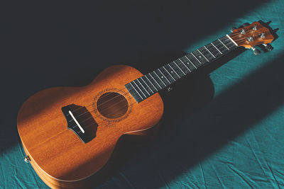 Close-up of guitar against black background