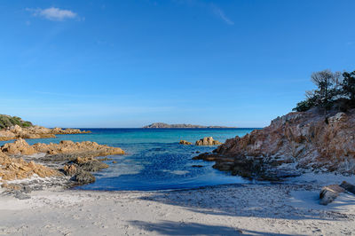 Scenic view of beach against blue sky