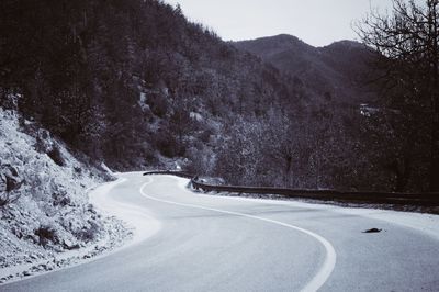 Road passing through snow covered mountain