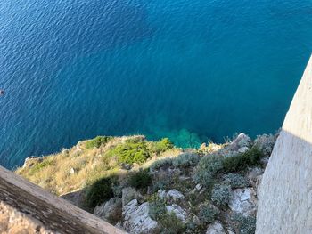 High angle view of rocks by sea