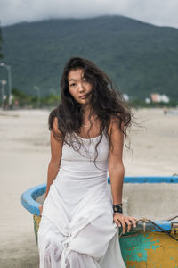 Portrait of young woman sitting on beach