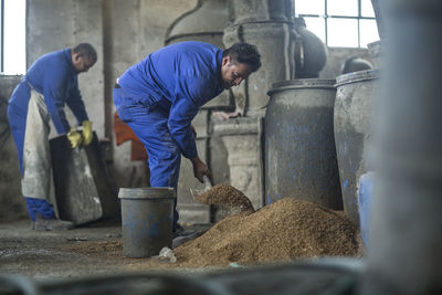 Two men working in industrial pot factory