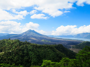 Scenic view of mountains against cloudy sky