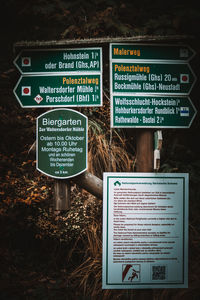 Close-up of information sign board on field