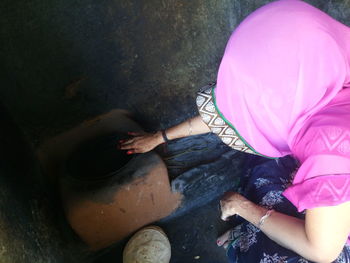 High angle view of woman in sari preparing food at kitchen