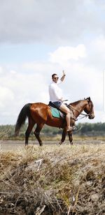 Man riding horse on field