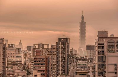 Taipei 101 amidst buildings against sky during dawn