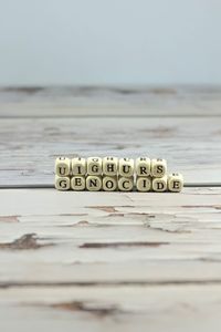 Close-up of text on table against sea