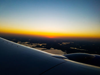 Aerial view of airplane wing against clear sky