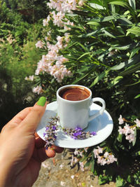 Cropped image of hand holding coffee cup